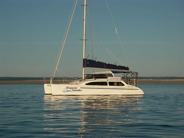 Cruising catamaran at anchor on calm water