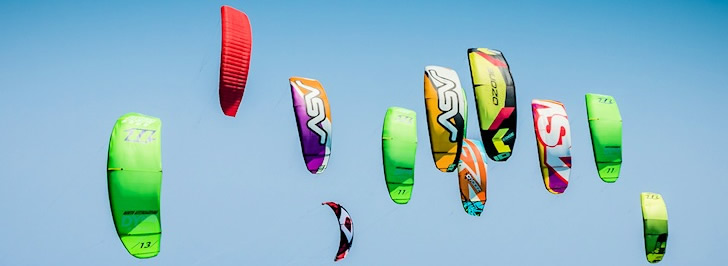 Colourful kites against a blue sky