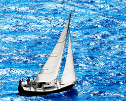 Cruising yacht under sail on deep blue water